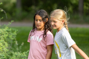Girls looking at a bush